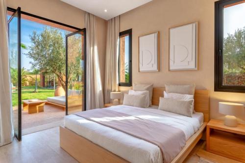 a bedroom with a large bed and a large window at Villa Dar Pampa in Marrakech