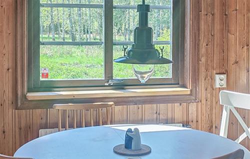 a dining room with a table and a window at Stunning Home In Lenhovda in Lenhovda