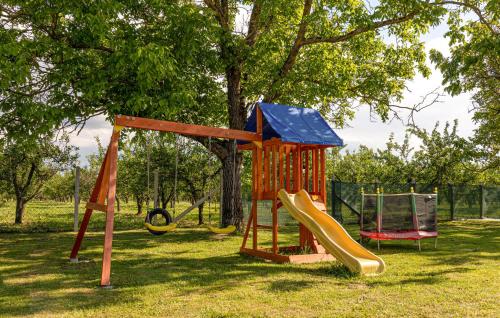 a playground with a slide and a slideintend at Amazing Home In Oljasi With Sauna in Oljasi