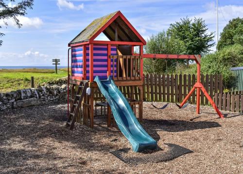 a playground with a slide and a play structure at Brighouse Bay Holiday Park in Kirkcudbright