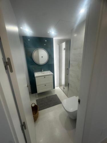 a bathroom with a toilet and a sink and a mirror at Miraflores golf penthouse with the pine view in Mijas