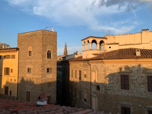 a view of the roofs of old buildings at Kairos by Florence Art Apartments in Florence