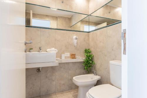 a bathroom with a toilet and a sink and a mirror at Gregoria Perez 3500 'b' - 1 Bd In Colegiales in Buenos Aires