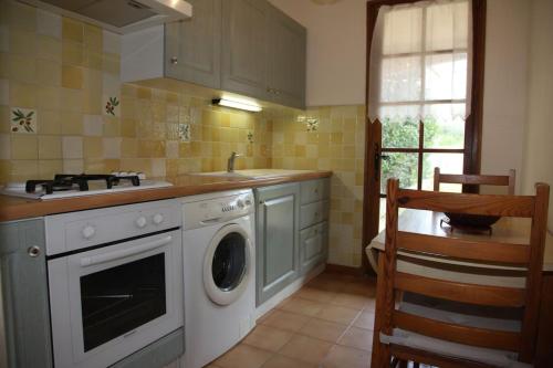 une cuisine avec une machine à laver et un évier dans l'établissement Coeur de ville avec jardin privatif, à Sanary-sur-Mer