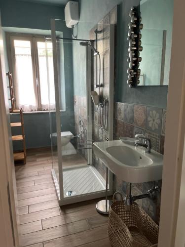 a bathroom with a shower and a sink and a toilet at Casa di Meo in Buti