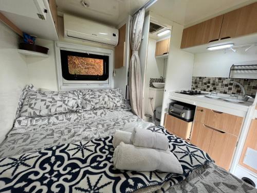 ein Schlafzimmer mit einem großen Bett in einem Wohnwagen in der Unterkunft Pousada Recanto Primavera in Piedade