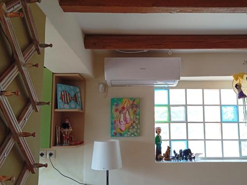 a room with a large window and a person standing in at Katia 's Country House in Sikión