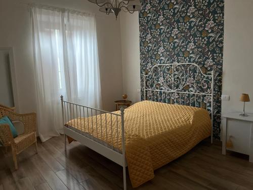 a bedroom with a bed with a patterned wall at Casa di Meo in Buti