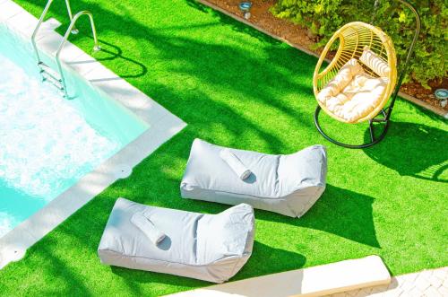 an overhead view of a lawn with a pool and pillows at Gournes Mare Luxury Villa with private pool in Gournes