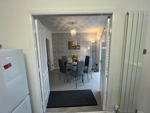 a dining room with a table and chairs at No 6, Ayr, 140m2, New Decor 2024, 3bedroom, detached house, with private gardens in Ayr