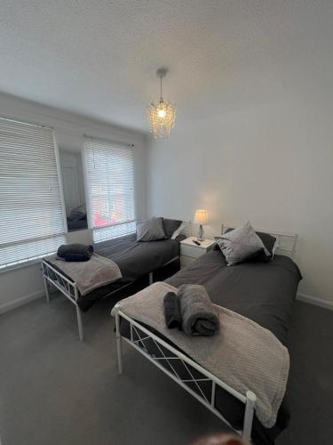 a living room with two beds and a couch at No 6, Ayr, 140m2, New Decor 2024, 3bedroom, detached house, with private gardens in Ayr