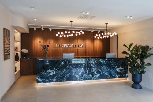 a lobby with a blue marble counter in a building at The Circus Living in Berlin