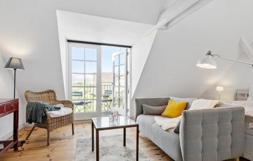 a living room with a couch and a table at Cozy Home In Haderslev With Kitchen in Haderslev