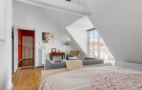 a white bedroom with a bed and a couch at Cozy Home In Haderslev With Kitchen in Haderslev