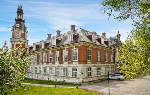 a large brick building with a clock tower on top at Cozy Home In Faaborg With Wifi in Fåborg