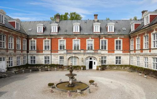 a large building with a fountain in front of it at Cozy Home In Faaborg With Wifi in Fåborg