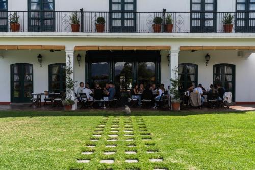 a group of people sitting outside of a building at Patios de Cafayate - Wine Hotel & Restaurant in Cafayate