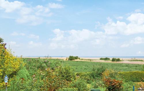 a field with the ocean in the background at Gorgeous Home In Saal With Wifi in Saal