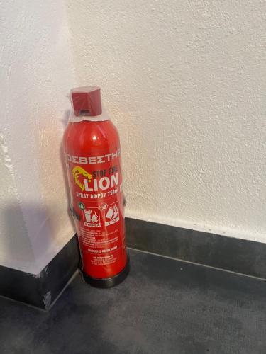 a bottle of red liquid sitting next to a wall at ElatoVillage in Elatochori