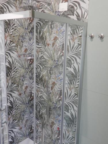a shower curtain in a bathroom with a wallpaper at Middle Town Palace in Tropea