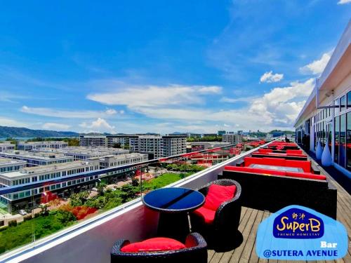 a balcony with red chairs and tables on a building at Sutera Luxurious Loft 1 in Kota Kinabalu