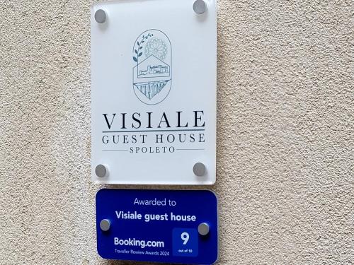 a sign for a guest house on a wall at Visiale guest house in Spoleto