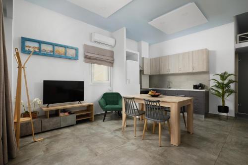 a kitchen and dining room with a table and chairs at Votsalo in Ierápetra