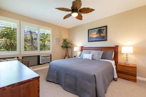 a bedroom with a bed and a ceiling fan at Grand Champions Villas #184 in Wailea
