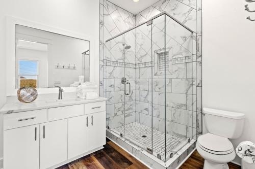 Un baño blanco con ducha y WC. en Blue Whale Your Luxury Beach Escape, en Destin