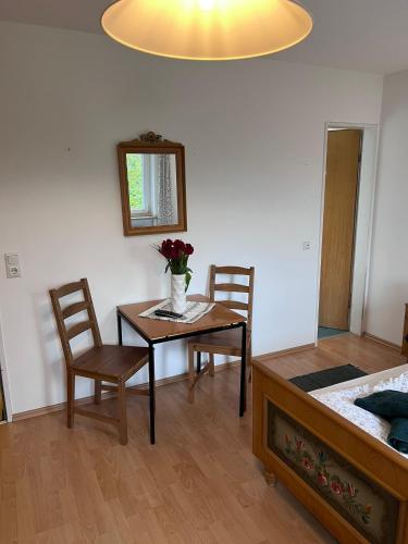 a room with a table and two chairs and a bed at Der Erberbauer in Piding