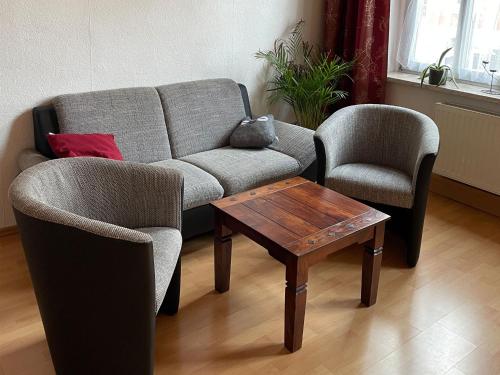 a living room with a couch and two chairs and a table at Ferienwohnung Gleißner Hartmann in Sangerhausen
