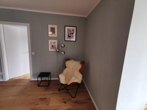 a room with a chair with a rug on the wall at Panorama Spa Lodges DAS.SCHILLER in Bad Gastein