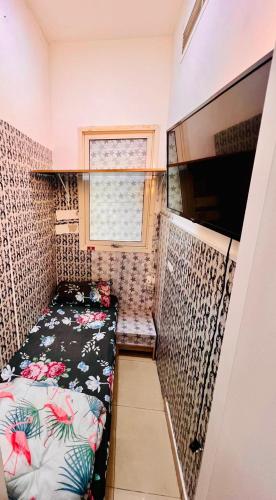 a small room with a bed and a window at Single Private Partition close to Metro in Dubai