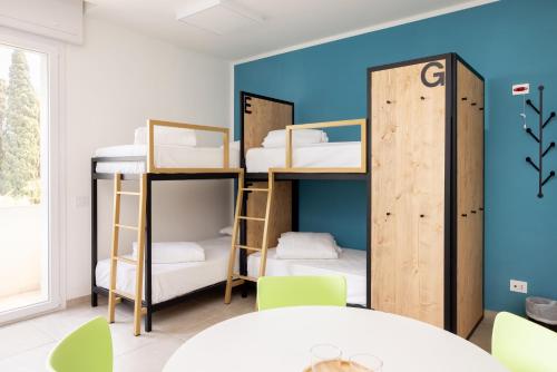 a room with bunk beds and a table at Ostello della Gioventù Brindisi in Brindisi