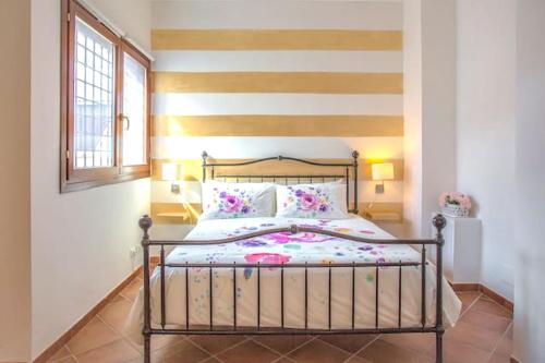 a bedroom with a bed with a striped wall at Studio with wifi at La Massimina Casal Lumbroso in La Massimina-Casal Lumbroso