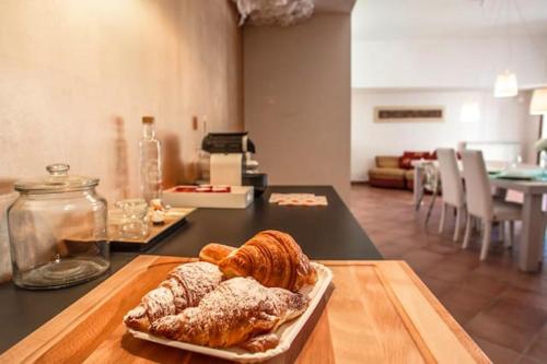 a plate of pastries on a table in a kitchen at Charming studio in La Massimina, 45 m² with private garden in La Massimina-Casal Lumbroso