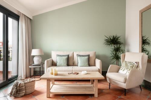 a living room with a couch and a coffee table at Palacio de Sancti Petri, a Gran Meliá - The Leading Hotels of the World in Chiclana de la Frontera