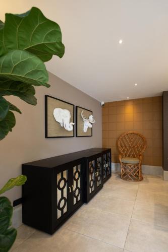 a room with black furniture and pictures on the wall at Camp David Ranch in Santiago de los Caballeros