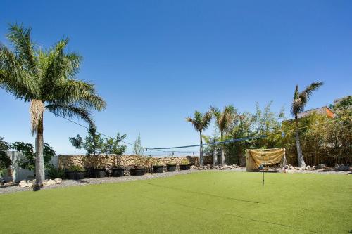 a golf course with a putting green and palm trees at Las Palmeras in Güimar
