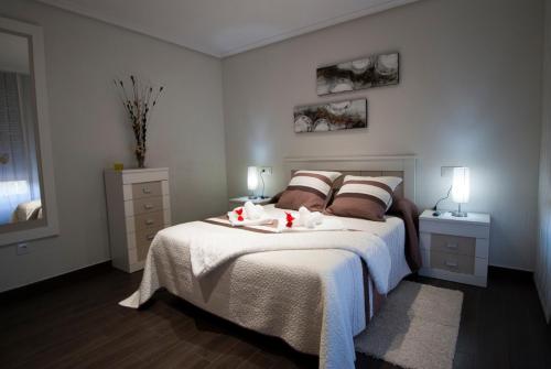 a bedroom with a bed with two candles on it at El Pilar de Don Gregorio in Pereruela