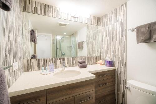 a bathroom with a sink and a mirror at Kamaole Sands 3-303 in Wailea