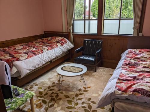 מיטה או מיטות בחדר ב-民泊サライ七城