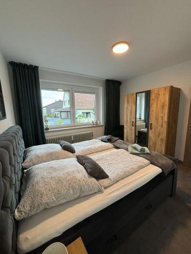 a large bed in a bedroom with a window at International 8 in Bad Harzburg