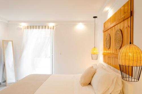 a bedroom with a bed with two pillows at Laza Beach in Skala