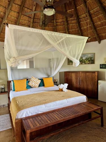 un dormitorio con una cama con dosel en Ku Sungula Safari Lodge, en Balule Game Reserve