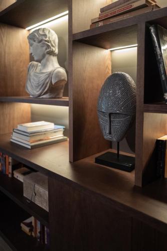 a bust of a head in a book shelf at Camp David Ranch in Santiago de los Caballeros