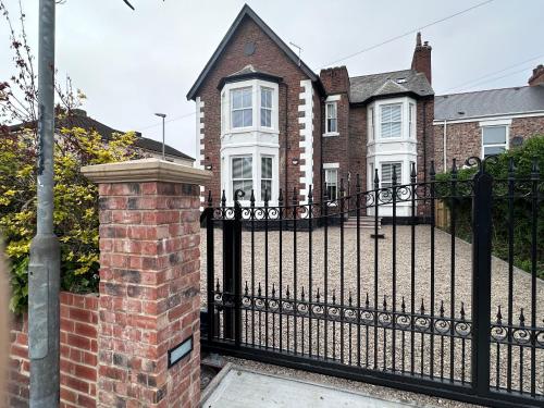a black wrought iron fence in front of a house at Wellington house in Blythe