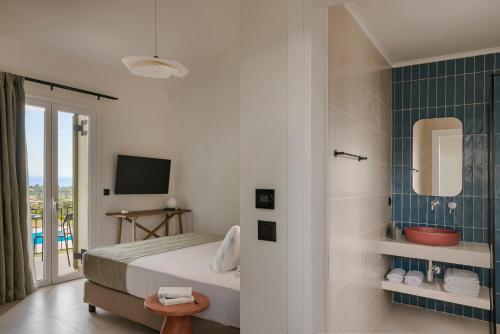 a hotel room with a bed and a bathroom at Rodi Studios in Karavadhos