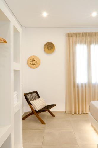 a living room with a bench and a window at Laza Beach in Skala