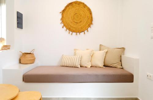 a bed with pillows on a white wall at Laza Beach in Skala